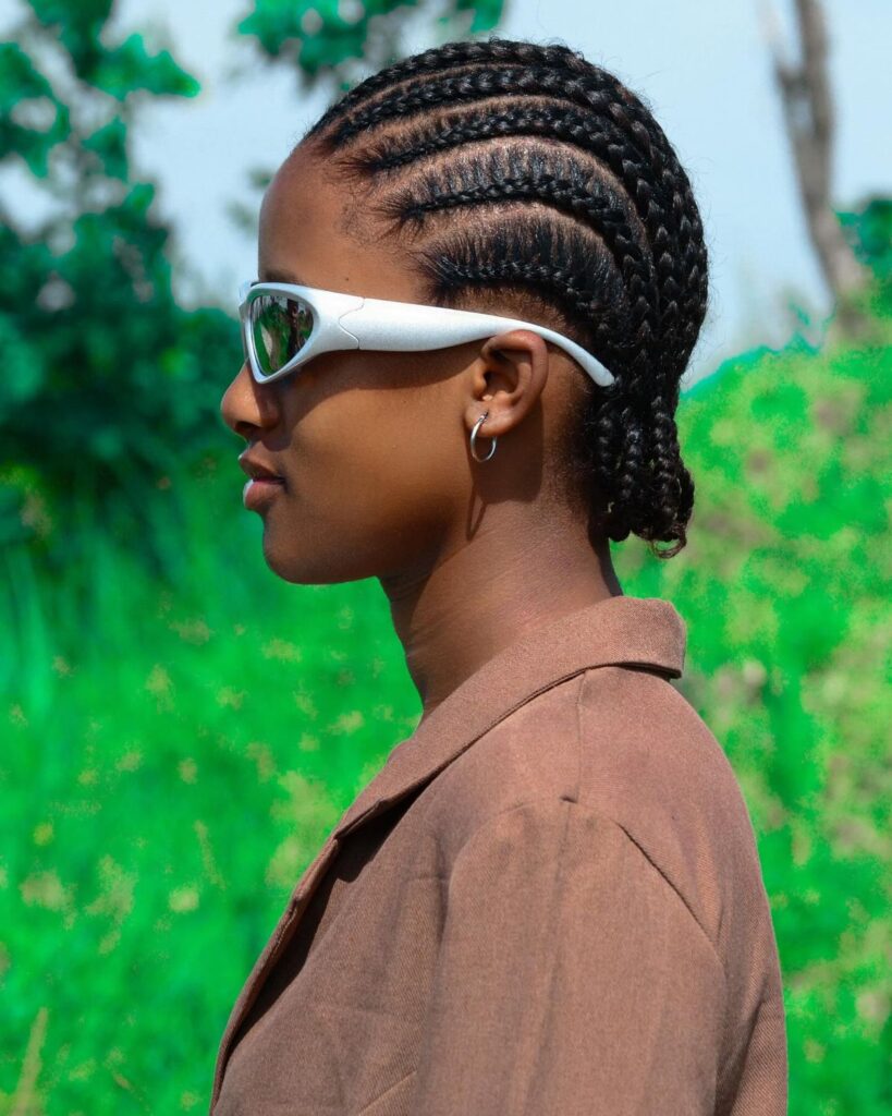 a girl with simple cornrows