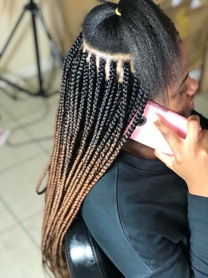 a lady making small box braids beautiful hairstyle