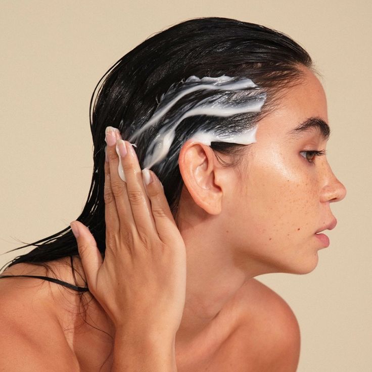 someone applying hair butter to her hair