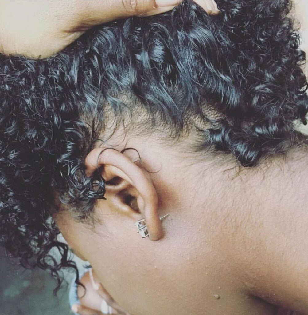 someone checking her hair porosity