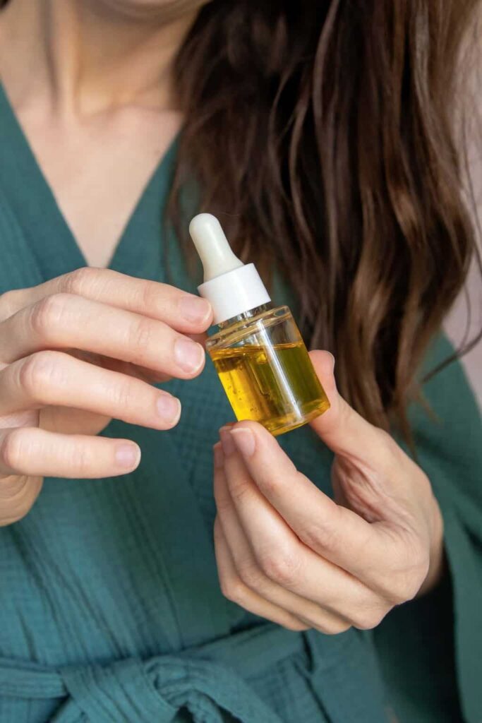 someone holding hair oil