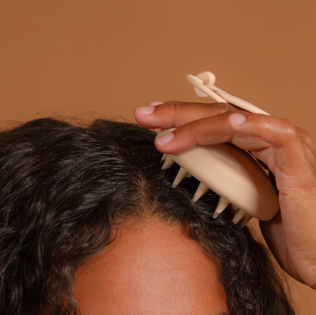 someone massaging her scalp