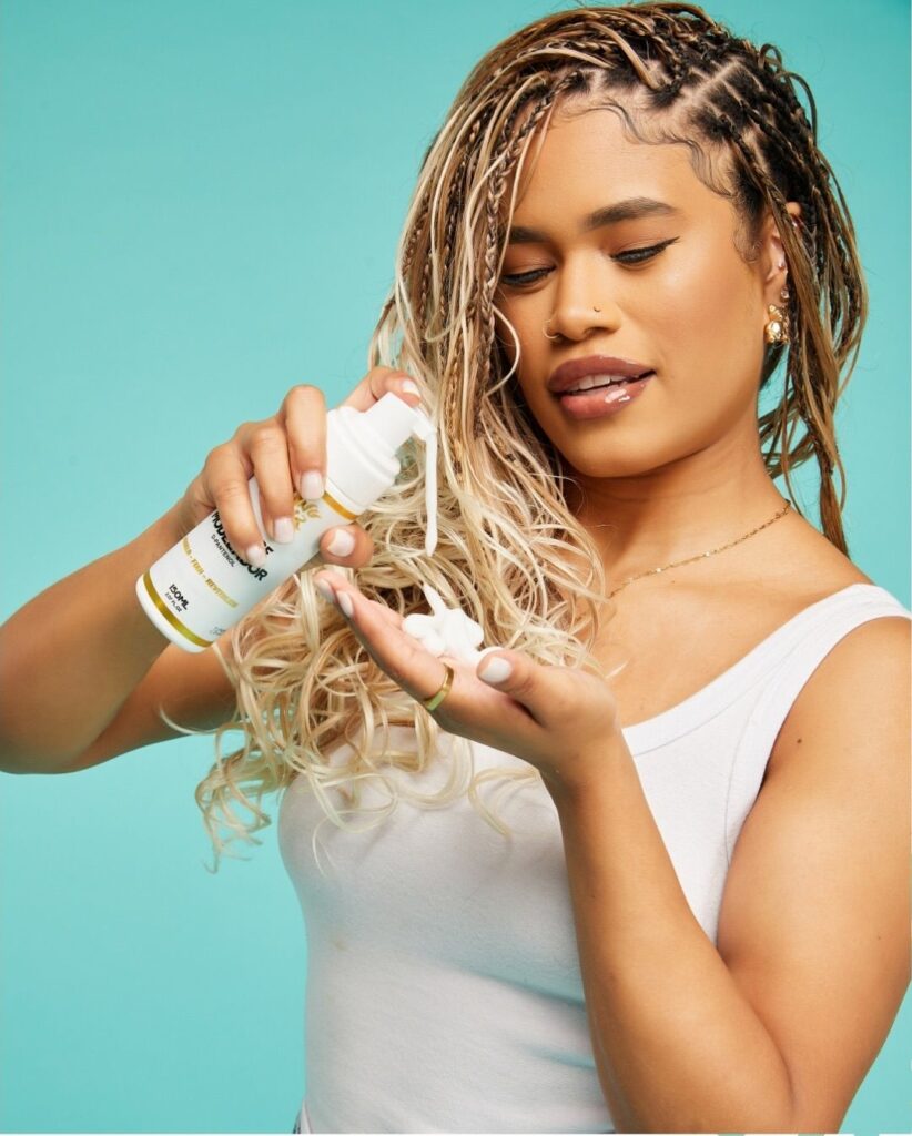 someone pouring out hair cream on her palm