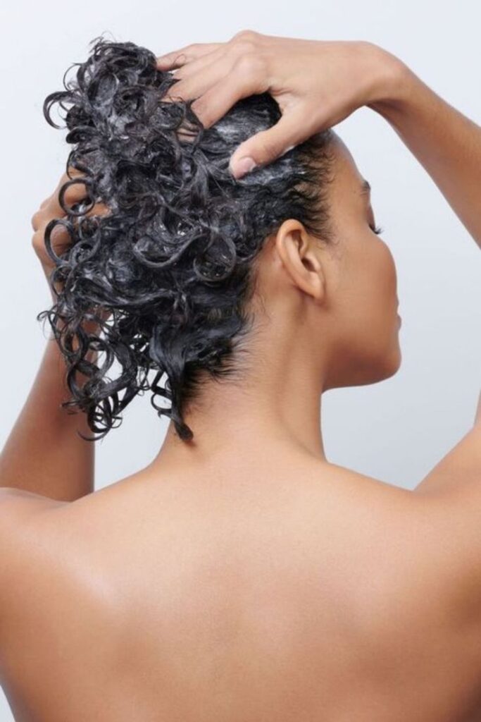 someone rubbing her hair