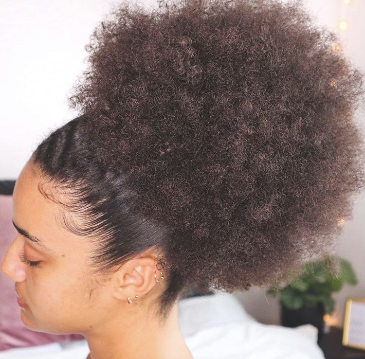 a fair girl with stretched afro puff hairstyle