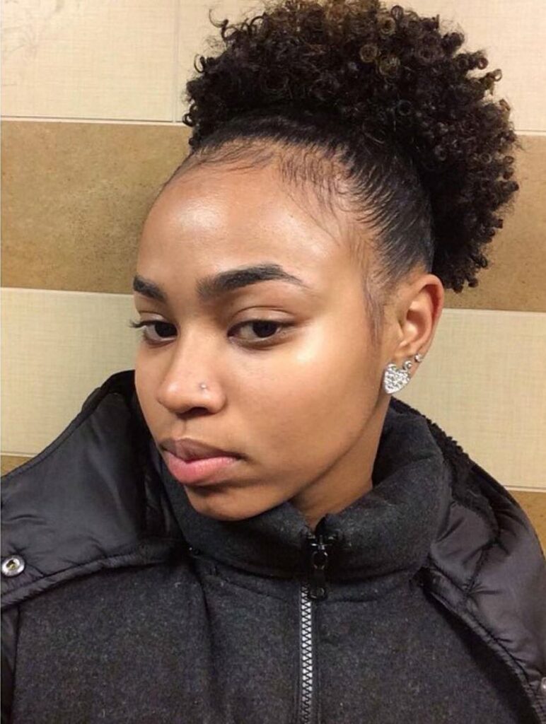 a girl with tiwa puff