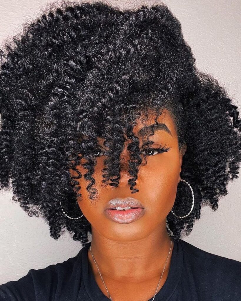 a lady with a twist out beautiful hairstyle