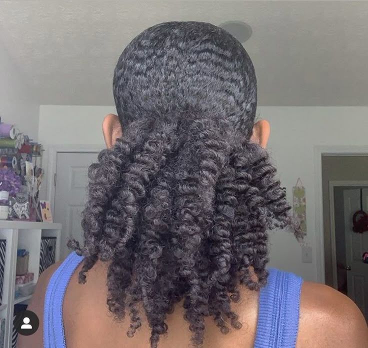 a girl with twist out puff quick natural hairstyle
