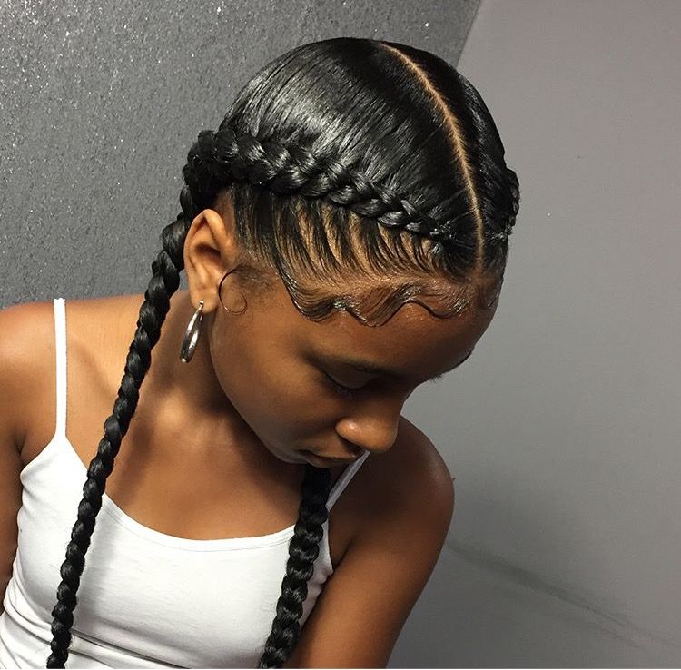 a girl with two cornrows