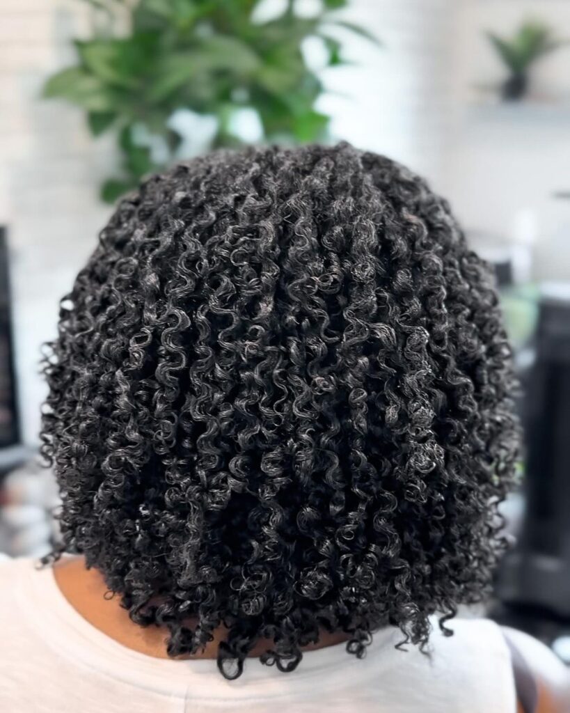 Afro hair styled with curl custard for soft, defined curls.