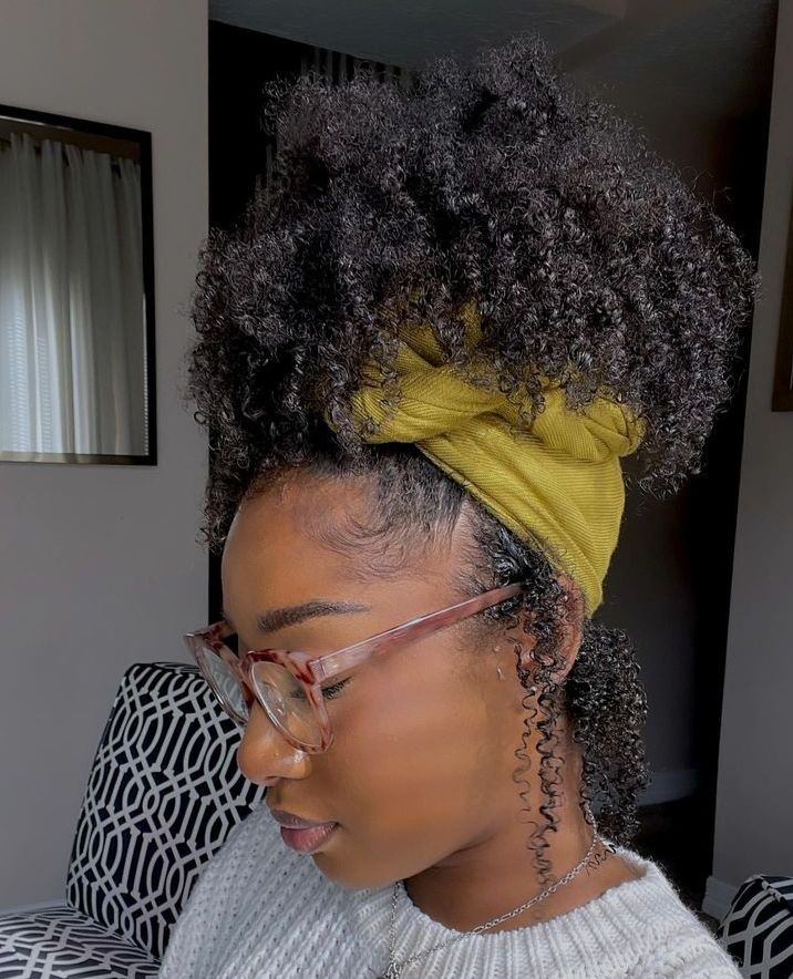 Girl styling her natural curls with a colorful scarf.