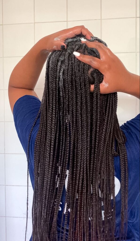 picture of a lady washing her hair in braids