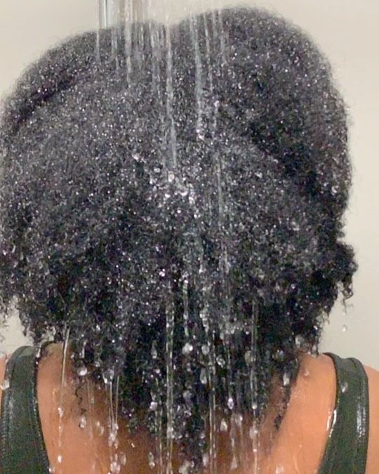 someone washing low porosity hair with cold water
