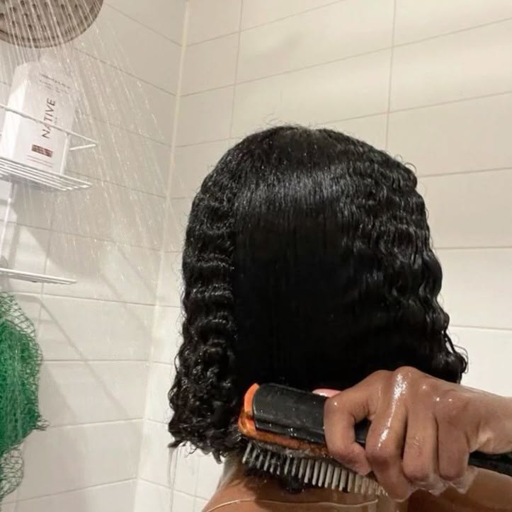 a girl washing and combing her hair