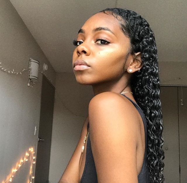 Girl with freshly styled wet curls on natural hair.