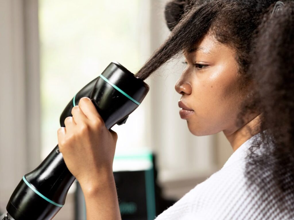 someone drying hair with hair dryer