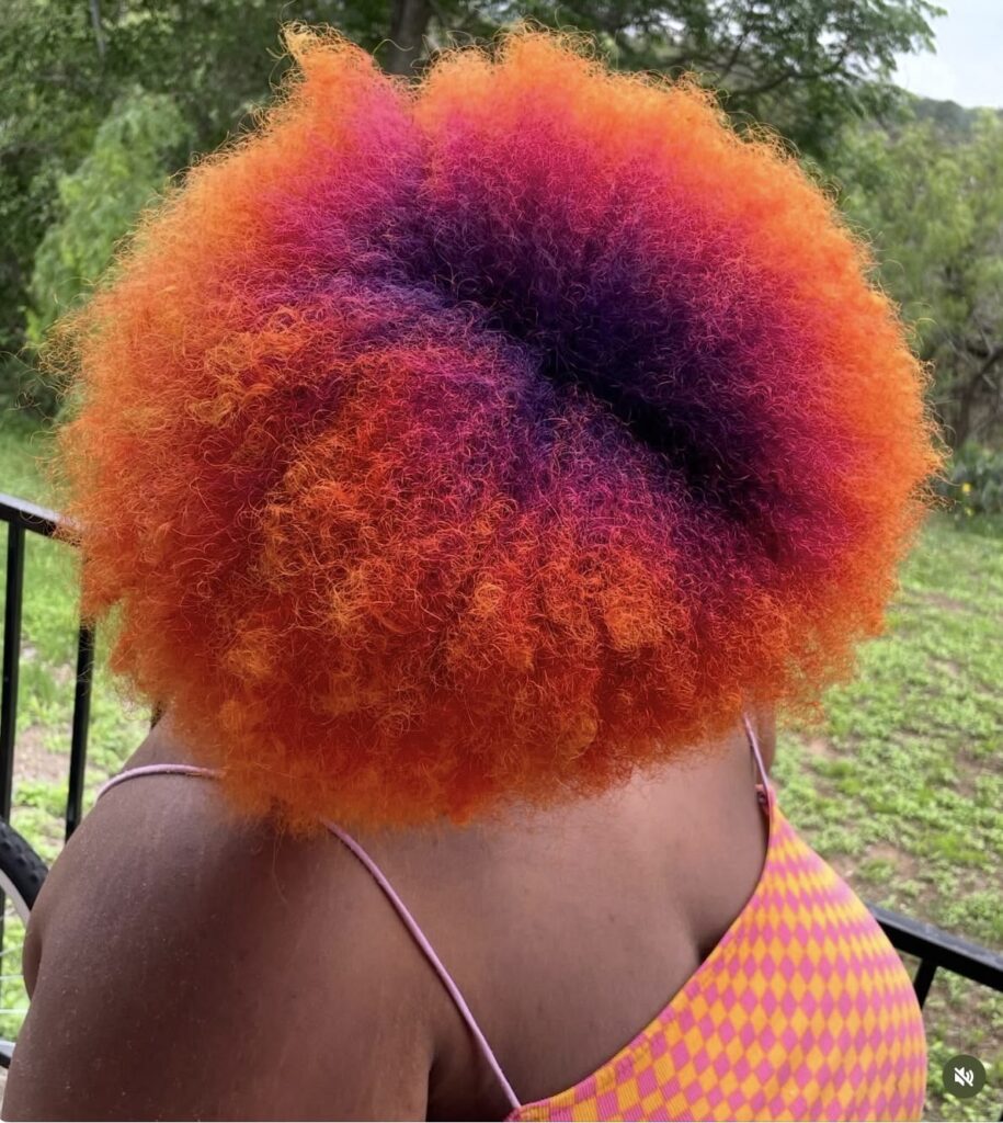 someone with colorful silk press roots