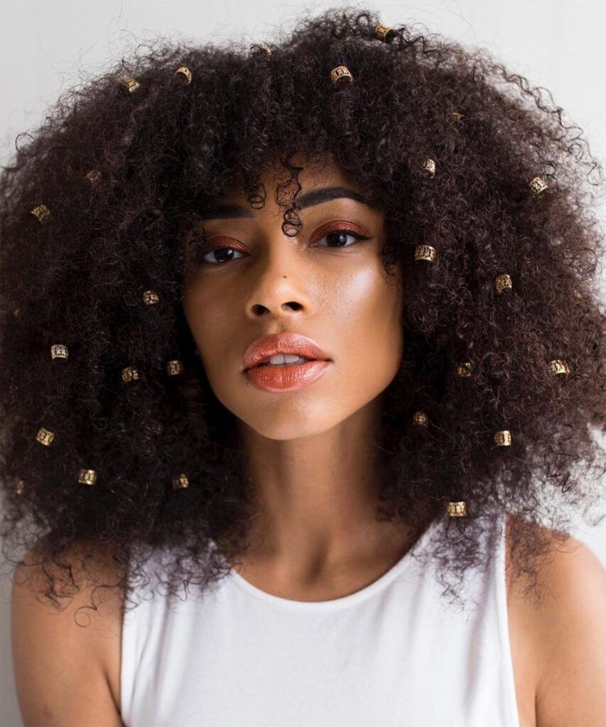 someone with afro with gold cuffs hairstyle