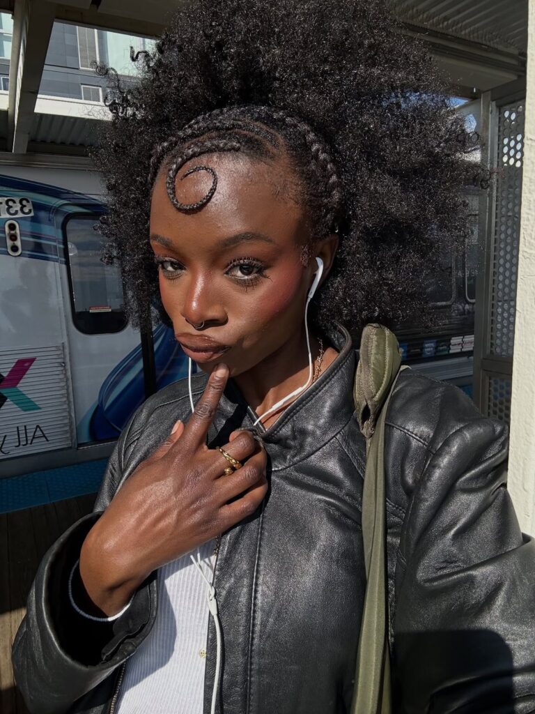someone with natural hair with micro braids edges