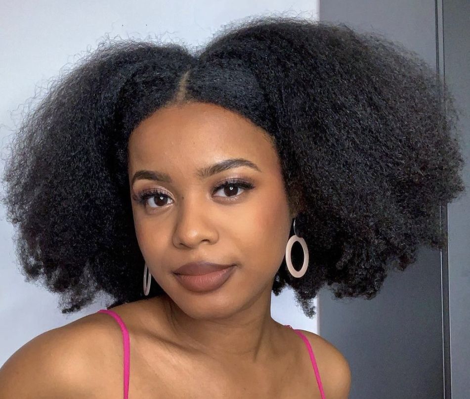 someone with natural hair with middle part