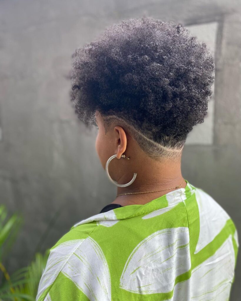 someone with afro with nepa undercut