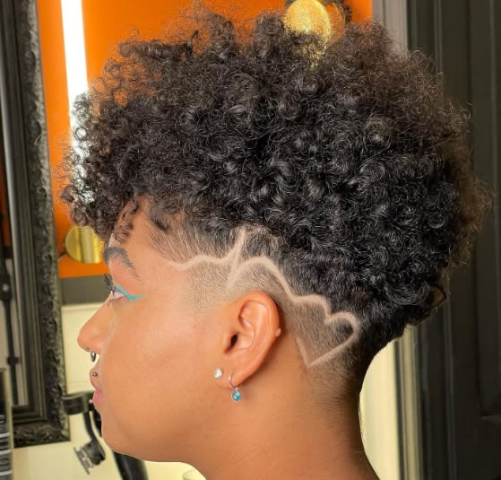 someone with afro shaved with design hairstyle