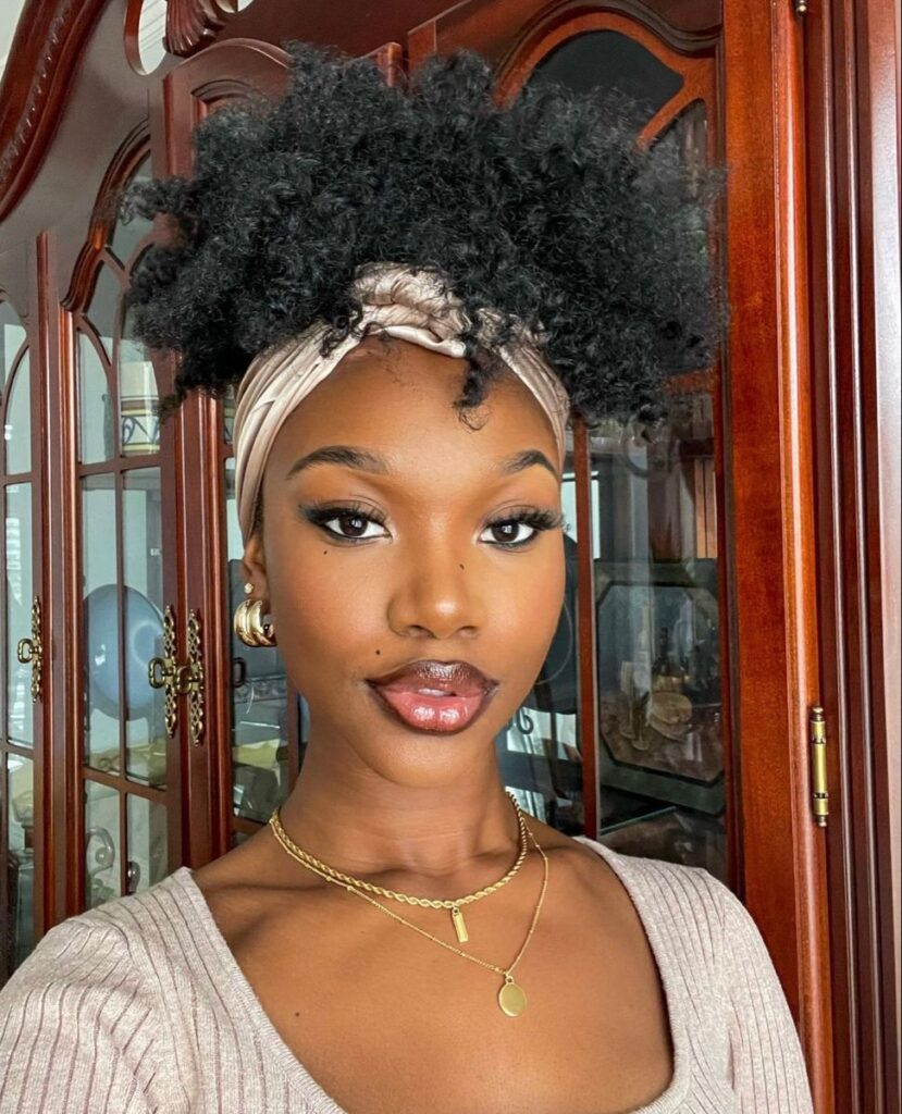 someone with afro with silk scarf wrap