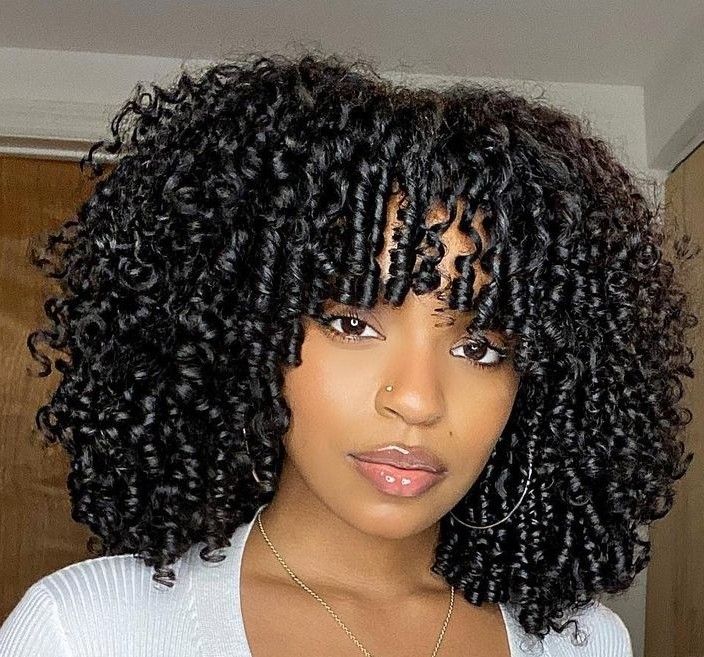 someone with soft curl bangs