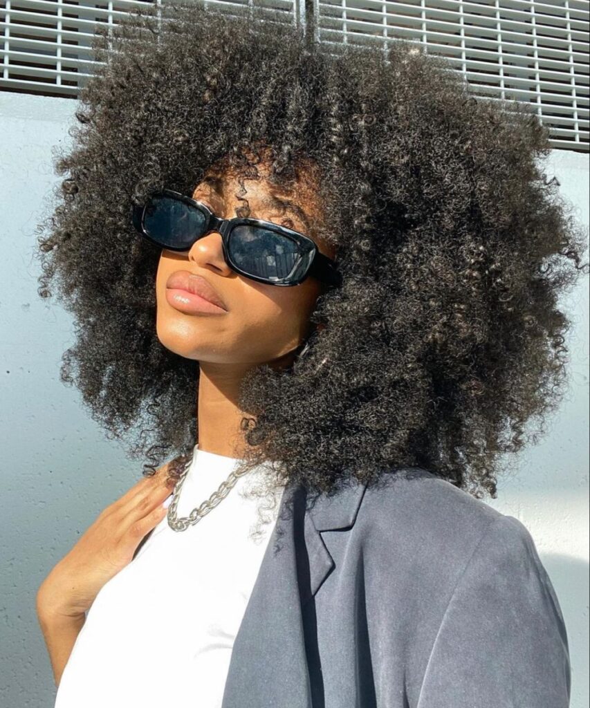 someone with hair with statement sunglasses
