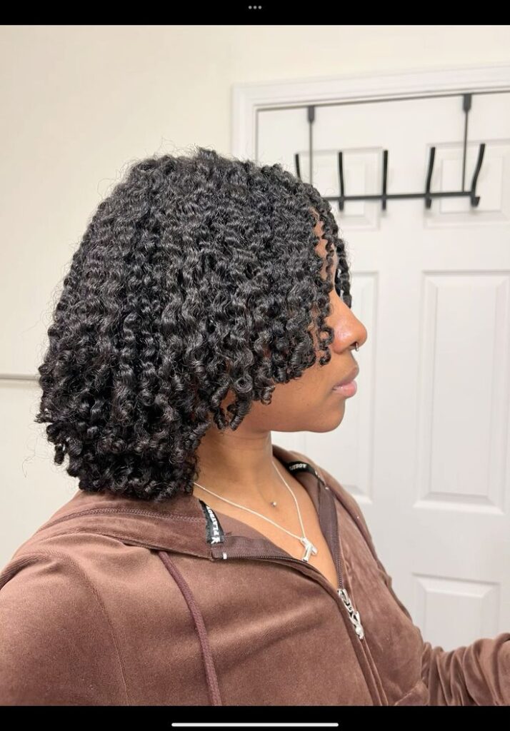 someone with natural curl finish with shine spray