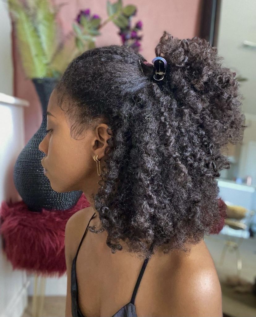 someone with natural hair half up half down