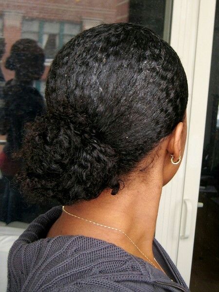 someone with natural hair low bun