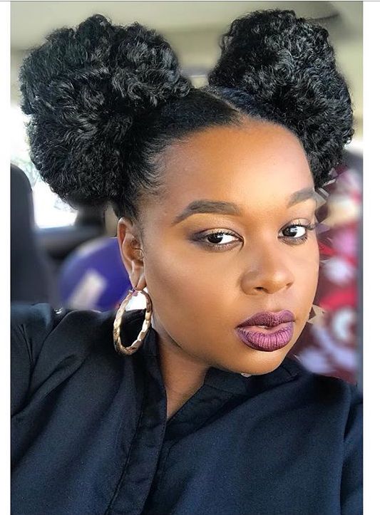 someone with natural hair space buns
