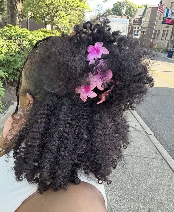 someone with natural hair with flowers