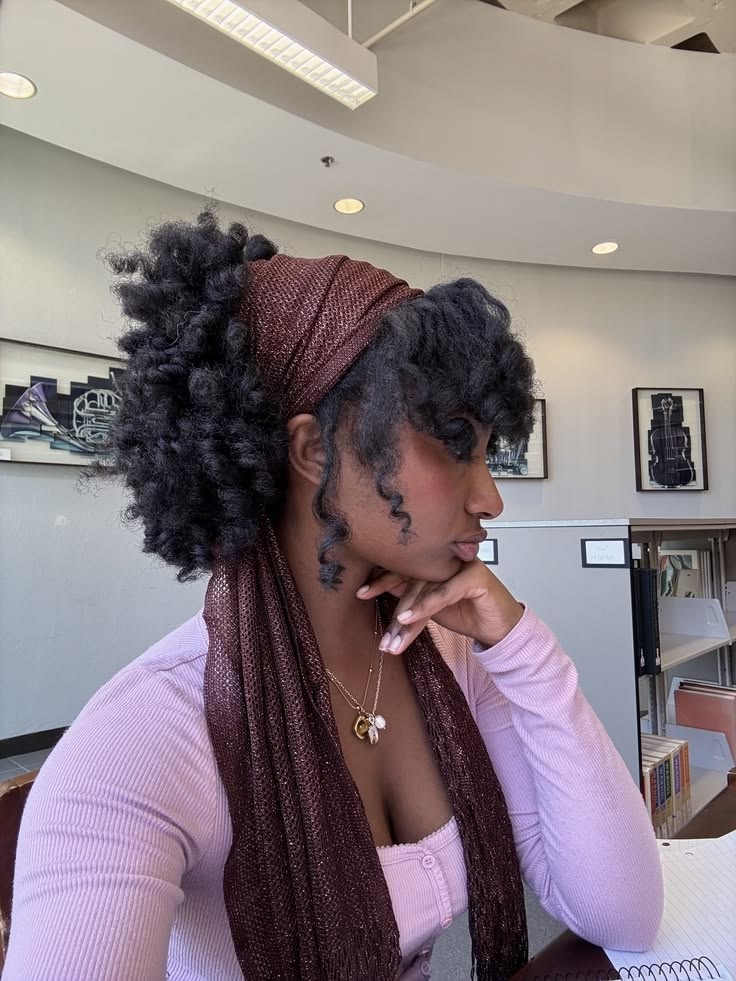 someone with natural curl with scarf accents