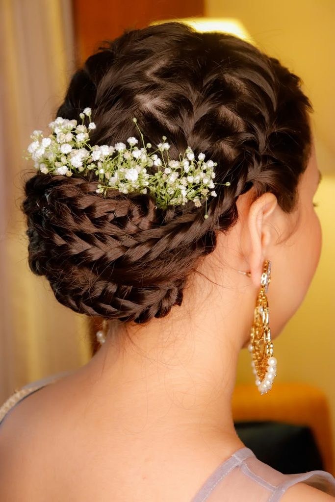 someone with braided bun with baby's breath