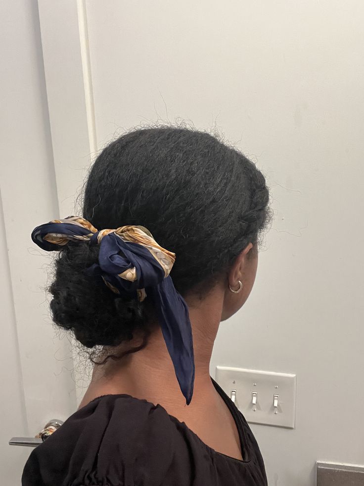 someone with braided bun with scarf accent professional hairstyle for the office