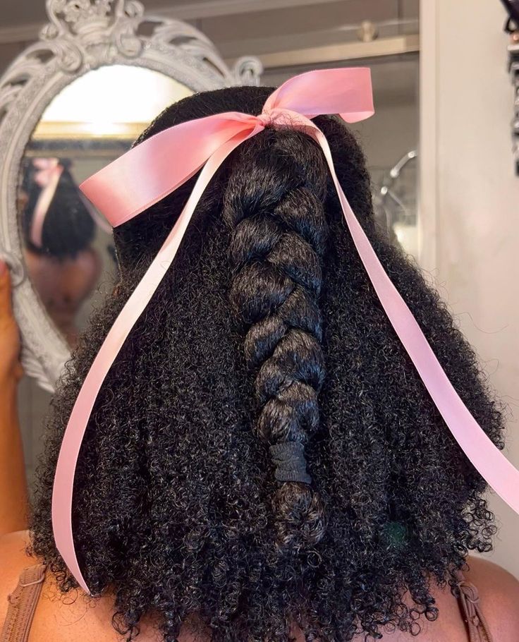someone with braided ponytail with ribbon