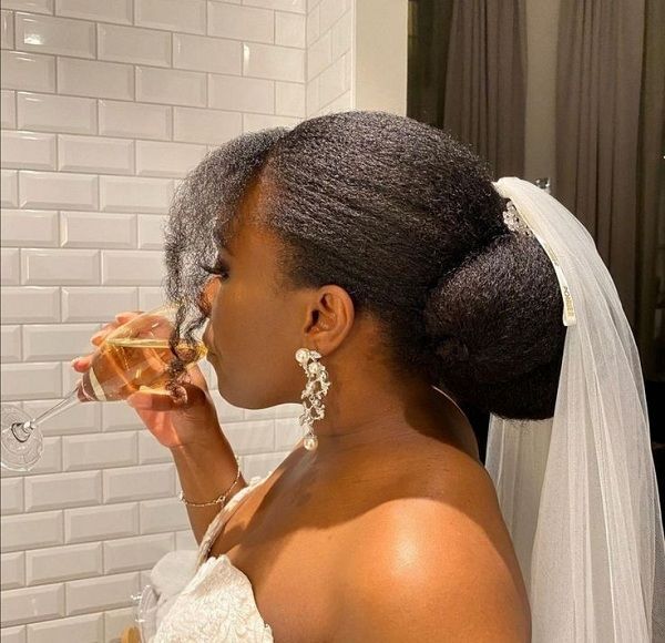 someone with bridal puff with veil afro wedding hairstyle