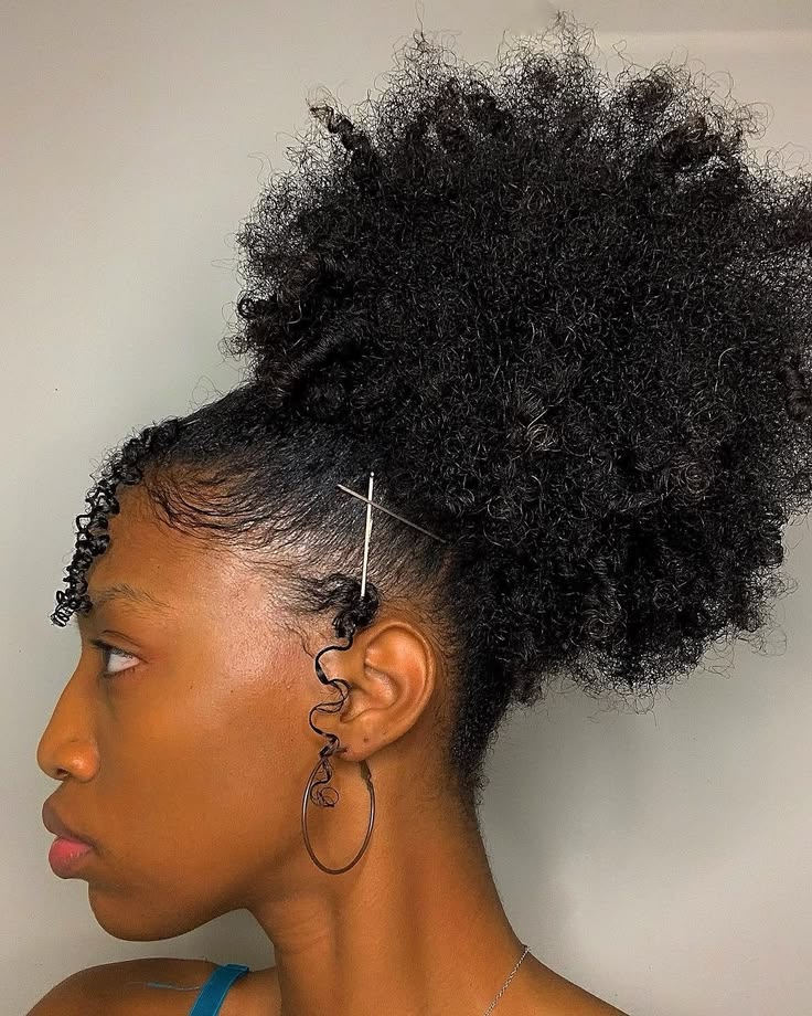 someone with curly hair updo with pins