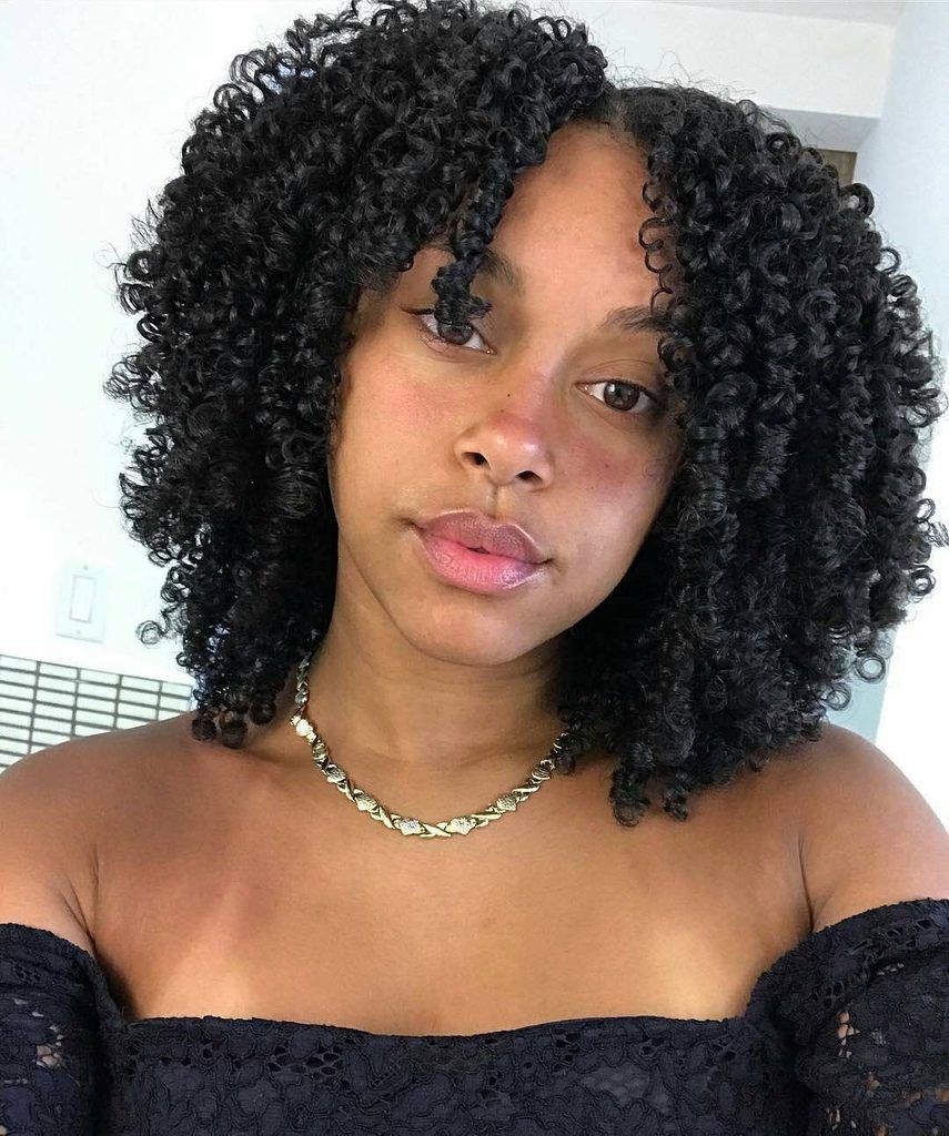 someone with curly afro with middle part