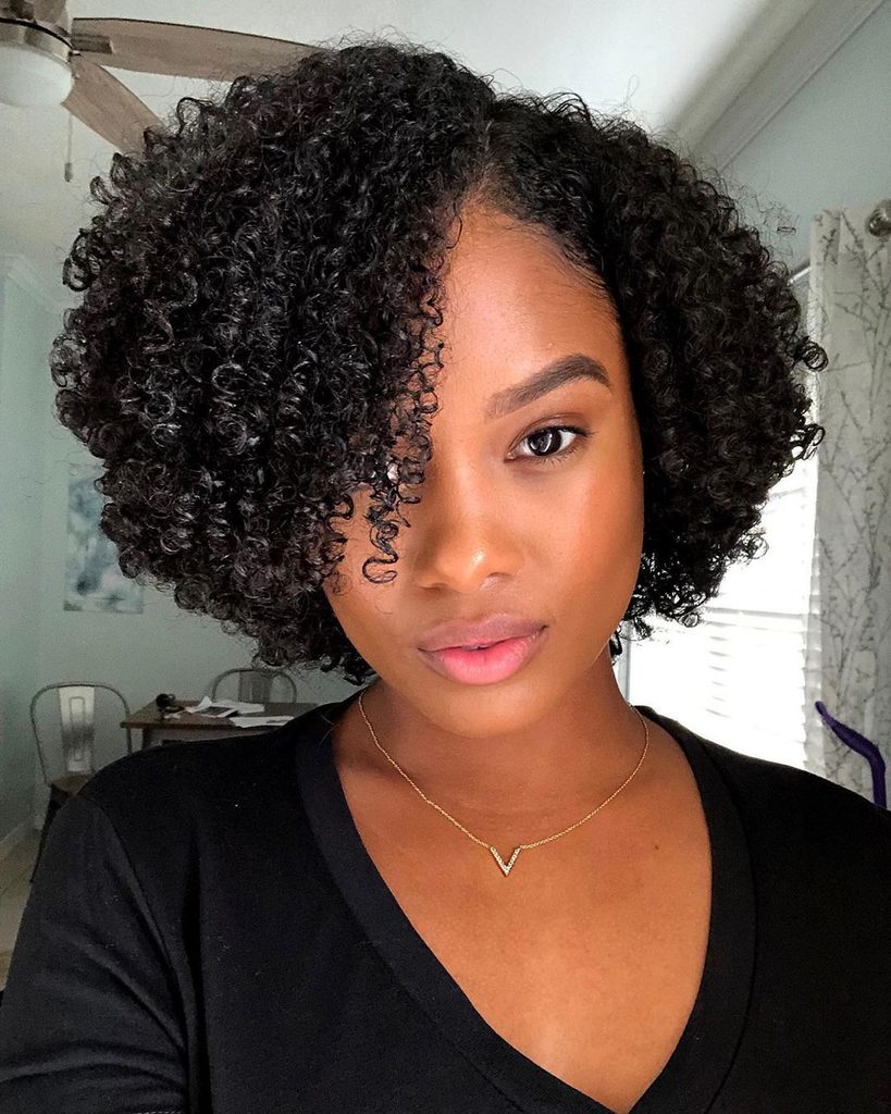 someone with curly bob professional hairstyle for the office