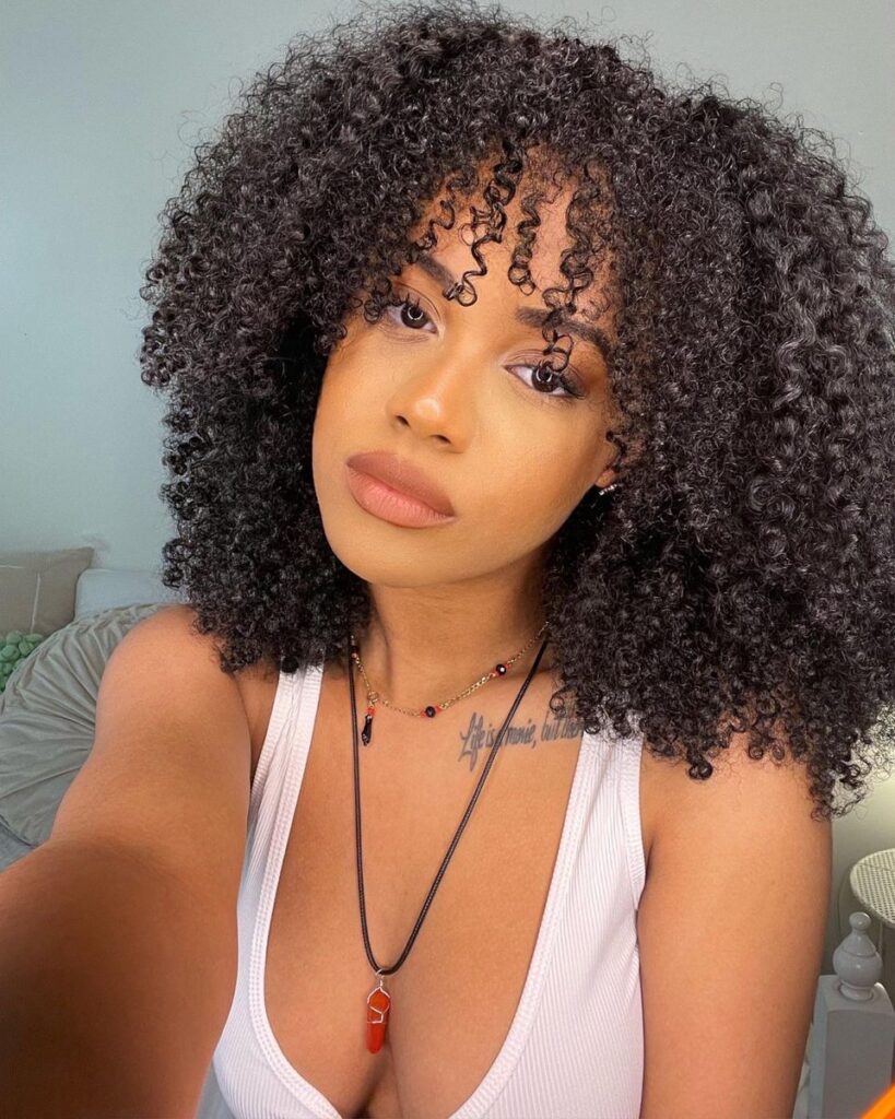 someone with curly fringe afro
