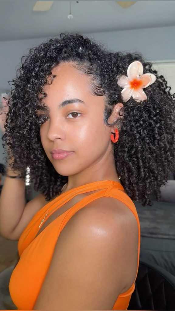 someone with defined curls with a side clip