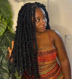 someone with distressed faux locs as protective styles for length retention