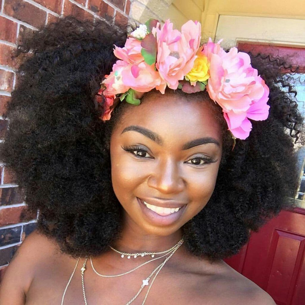 someone with flower crown afro wedding hairstyle