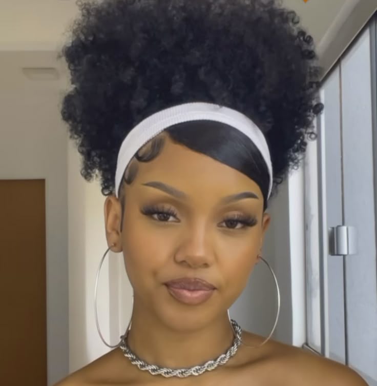 someone with fluffy twist out with a headband date night hairstyle for afro hair