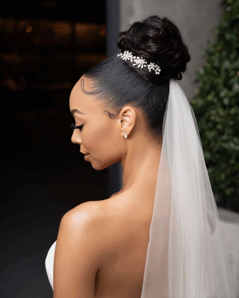 someone with high puff with birdcage veil
