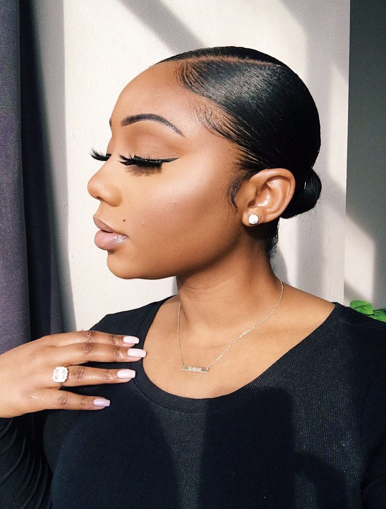 someone with sleek bun professional hairstyle for the office
