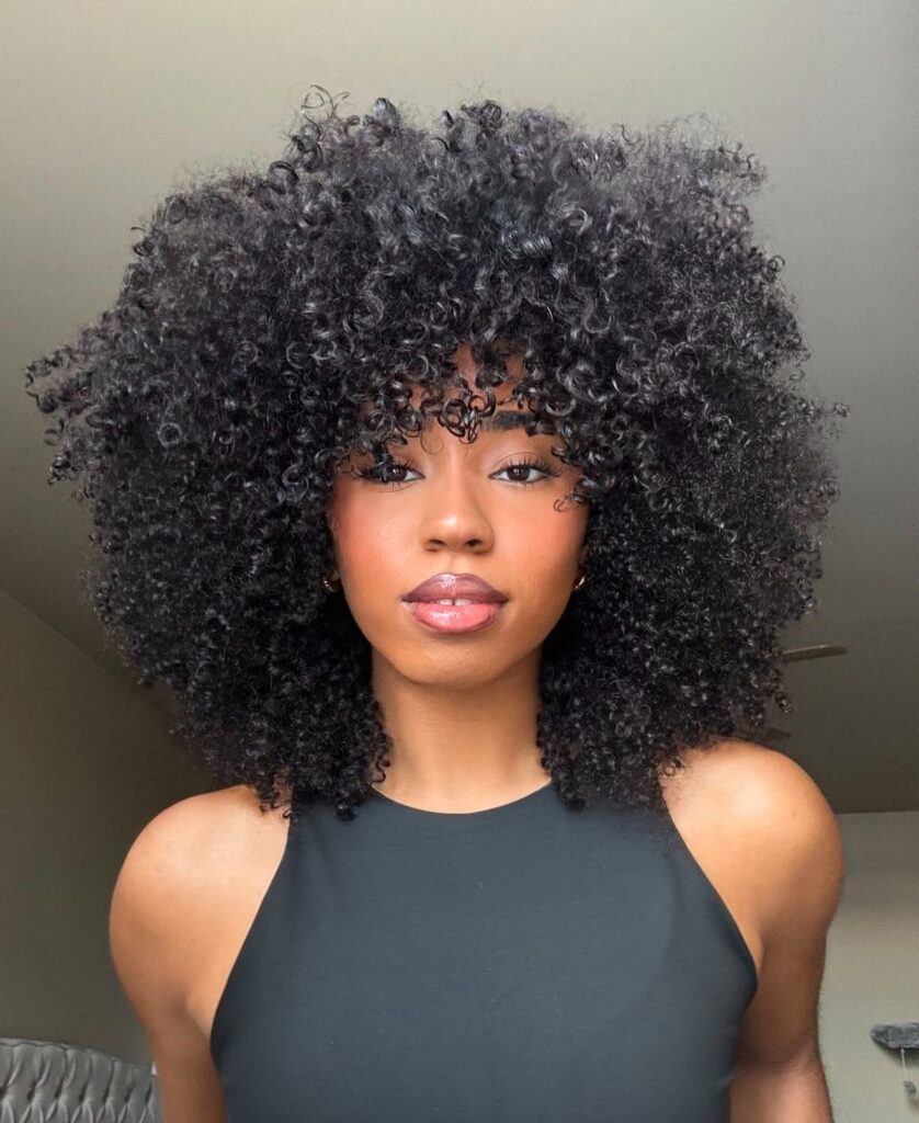 someone with layered afro shaped hairstyle